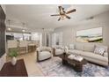 Bright living room featuring modern furnishings, ceiling fan, and an open floor plan leading into the kitchen area at 390 17Th Nw St # 2005, Atlanta, GA 30363