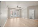 Bright and airy living room featuring a modern ceiling fan, fresh paint, and wood floors at 390 17Th Nw St # 2005, Atlanta, GA 30363