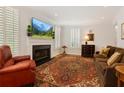 Cozy living room featuring a fireplace, large windows, plantation shutters and a comfortable seating arrangement at 1117 Haven Glen Ne Ln, Brookhaven, GA 30319