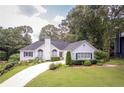This is a well-maintained white house with verdant front yard and curving driveway at 2355 Quail Creek Ter, Buford, GA 30519