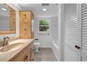 Hall bathroom featuring neutral tile, a tub/shower combo and ample storage at 2585 Regency E Dr, Tucker, GA 30084