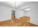 Open dining and living room featuring crown moulding, hardwood floors and natural light at 2585 Regency E Dr, Tucker, GA 30084
