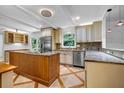 Bright eat-in kitchen features stainless appliances, granite counters and tile flooring at 2585 Regency E Dr, Tucker, GA 30084