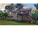 Rear view of the home showcasing back deck, and outdoor space at 310 Willow Ln, Temple, GA 30179
