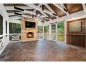 Cozy covered patio with a stone fireplace, ceiling fan, and wood accents at 1691 Houghton N Ct, Atlanta, GA 30338