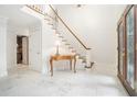 Bright foyer featuring marble floors, a staircase, and elegant details at 1691 Houghton N Ct, Atlanta, GA 30338