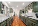 Spacious kitchen featuring custom green cabinetry, granite countertops, and stainless steel appliances at 1691 Houghton N Ct, Atlanta, GA 30338