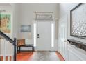 Welcoming foyer with hardwood floors, a bench, and decorative art at 508 Keeneland Ave, Woodstock, GA 30189