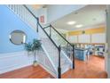 Bright foyer features a staircase with white railings and hardwood floors at 508 Keeneland Ave, Woodstock, GA 30189