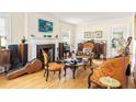 Sunlit living area with hardwood floors, cozy fireplace, comfortable seating, and ample natural light at 348 7Th Ne St, Atlanta, GA 30308