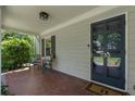 Inviting front porch with brick floor, seating, and stylish front door with house number at 733 Greenview Ne Ave, Atlanta, GA 30305