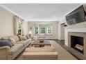 Spacious living room featuring a fireplace, large windows, and elegant furnishings at 733 Greenview Ne Ave, Atlanta, GA 30305