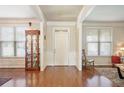 Bright foyer featuring hardwood floors, white trim, and a glimpse into the adjoining rooms at 218 Ballymore Lane Ln, Acworth, GA 30102