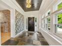 Elegant foyer with stone floors, decorative wallpaper, and natural light streaming through windows at 28 Peachtree Hills Ne Ave, Atlanta, GA 30305