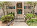 Welcoming condo entrance with arched doorway, lush plantings, and classic architectural charm at 3236 Henderson Mill Rd # 1, Chamblee, GA 30341