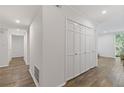 Bright hallway with hardwood floors leads to a large closet and a glimpse of nature at 3236 Henderson Mill Rd # 1, Chamblee, GA 30341
