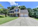 Charming two-story home with a manicured lawn, inviting front porch, and two-car garage at 5385 Spotted Fawn Ct, Suwanee, GA 30024