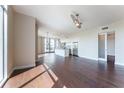 Spacious living area featuring dark hardwood floors, natural light, and a modern ceiling fan at 1820 Peachtree Nw St # 608, Atlanta, GA 30309