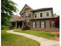 Charming two-story home with a blend of stone and brick, enhanced by a winding walkway and verdant landscaping at 2845 Echols Road Rd, Cumming, GA 30041