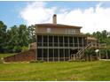 Expansive backyard featuring a screened-in porch and deck, perfect for outdoor entertaining and relaxation at 2845 Echols Road Rd, Cumming, GA 30041