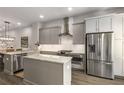 Modern kitchen with gray cabinets, stainless steel appliances, and a center island at 4358 Parkside Pl, Atlanta, GA 30342