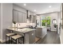 Stylish kitchen featuring gray cabinets, stainless steel appliances, and granite countertops at 4358 Parkside Pl, Atlanta, GA 30342