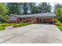 Charming brick ranch-style home with a spacious driveway, covered parking, and beautiful landscaping at 2628 Tanglewood Rd, Decatur, GA 30033