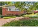 Charming exterior showing brick facade and manicured garden, presenting a classic curb appeal at 2628 Tanglewood Rd, Decatur, GA 30033