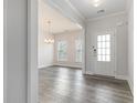 Bright entryway featuring stylish wood flooring and a modern light fixture at 129 Academy Ln, Canton, GA 30114