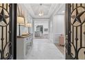 Elegant foyer with decorative tile floor, stylish console table and an open view to the kitchen at 332 Mount Zion Rd, Oxford, GA 30054