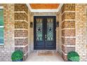 Close-up of a brick entryway and decorative double front doors, adding a touch of elegance at 332 Mount Zion Rd, Oxford, GA 30054