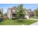 Attractive home featuring a well-maintained lawn, brick and siding exterior, and a cozy front porch at 6213 Old Kingston Dr, Atlanta, GA 30331