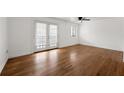 Open living area with hardwood floors, ceiling fan, and sliding doors to the balcony at 1355 Euclid Ne Ave # A8, Atlanta, GA 30307