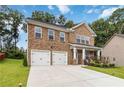 Lovely two-story brick home featuring a welcoming front porch and a spacious driveway at 1469 Cliff View Ter, Conyers, GA 30012