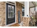 Close-up of a front door with a welcome sign and decorative plants creating curb appeal at 1469 Cliff View Ter, Conyers, GA 30012
