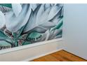 Close-up of a floral wall mural with botanical details and the artist's signature at 15 Waddell Ne St # 101, Atlanta, GA 30307