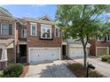 Charming brick townhome with a two-car garage and a small balcony above the garage at 6403 Queens Court Trce, Mableton, GA 30126