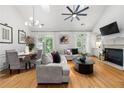 Open-concept living room featuring a fireplace, hardwood floors, and abundant natural light at 6403 Queens Court Trce, Mableton, GA 30126