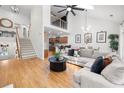 Open-concept living room with high ceilings, hardwood floors, and lots of natural light at 6403 Queens Court Trce, Mableton, GA 30126
