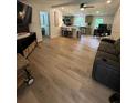 Open-concept living room features modern flooring, a comfortable couch and lots of natural light at 241 Wooten Ct, Canton, GA 30114