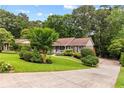 Landscaped front yard with mature trees and charming one story home at 621 Windgrove Se Dr, Marietta, GA 30067