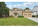 Charming two-story home featuring a manicured lawn, beautiful landscaping, and a welcoming front entrance at 3595 Millwater Xing, Dacula, GA 30019