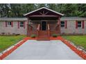 Inviting front porch with new landscaping and a modern walkway, enhancing curb appeal at 4670 Brookwood Dr, Cumming, GA 30041