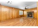 Bright living room with a stone fireplace, ceiling fan, and hardwood floors at 501 Samaritan Dr, Cumming, GA 30040