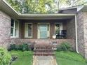 Inviting front porch with rocking chair and well-maintained landscaping at 747 Dogwood Cir, Norcross, GA 30071
