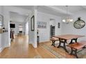 Bright dining room showcasing hardwood floors, a modern chandelier, and classic wainscoting details at 4520 Odum Lake Trl, Cumming, GA 30040