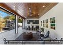 Covered outdoor living space with seating area, ceiling fan, and an outdoor kitchen and bar setup at 1658 E Clifton Ne Rd, Atlanta, GA 30307