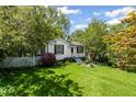 Charming home features a well-manicured lawn and inviting curb appeal with fresh landscaping at 881 Mclinden Se Ave, Smyrna, GA 30080