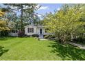 Charming home features a well-manicured lawn and inviting curb appeal with fresh landscaping at 881 Mclinden Se Ave, Smyrna, GA 30080