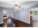 Cozy living room with refinished hardwood floors, white trim and a fireplace visible from an open layout at 881 Mclinden Se Ave, Smyrna, GA 30080